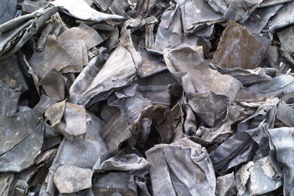 Close-up on container of scrap lead metal